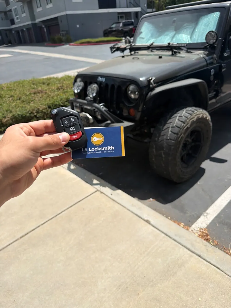 Jeep vehicle and key shown with an LS Locksmith business card