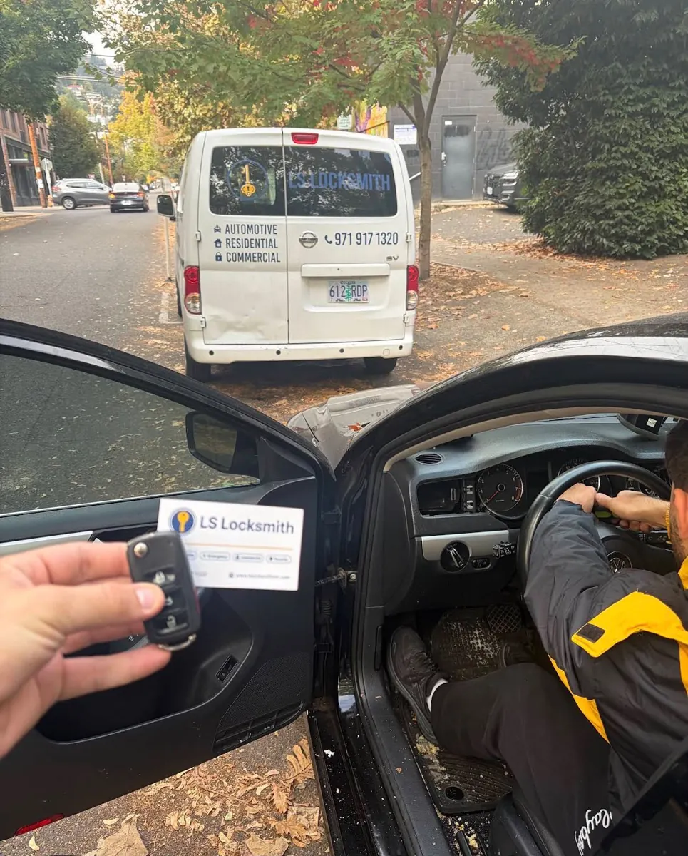 Vehicle key shown with an LS Locksmith mobile service van nearby