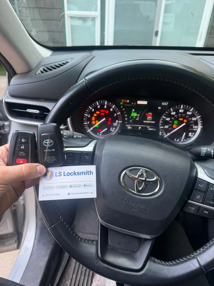 Toyota steering wheel, key fob, and LS Locksmith business card