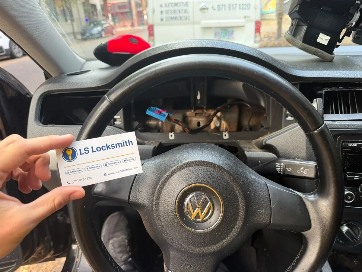 Volkswagen steering wheel with an LS Locksmith business card